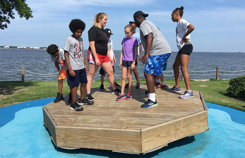 Campers and staff in a balance activity
