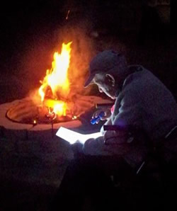 James Hollandsworth reading by a fire