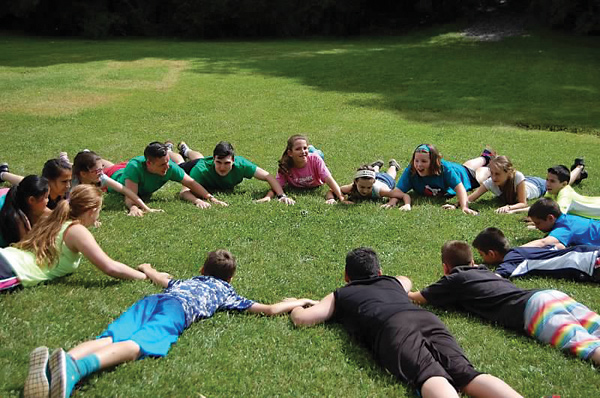 Campers and staff lying in a circle