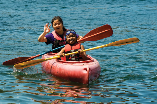 Camper and counselor in canoe