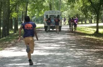 staff running to great camper bus