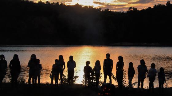 campers and staff silhouettes at sunset