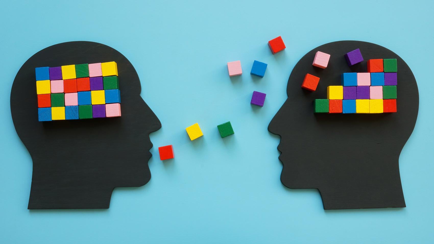 Two head silhouettes with colorful cubes