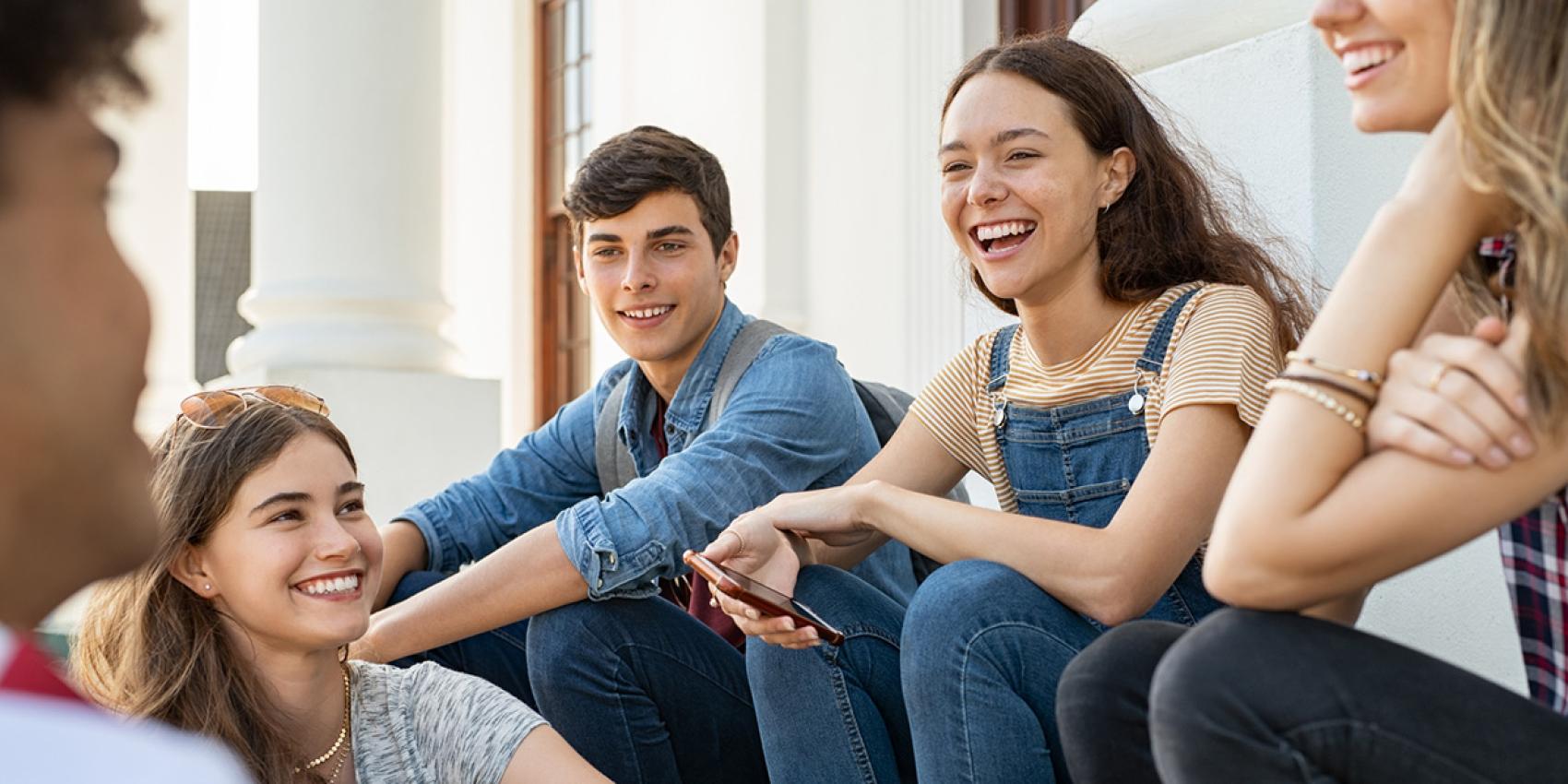 stock photo of friends sitting and laughing
