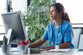 Nurse in front of computer at desk