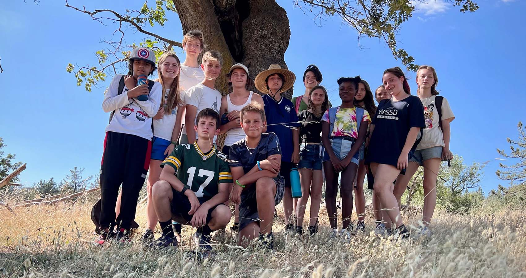 Campers posing by tree at Camp Stevens