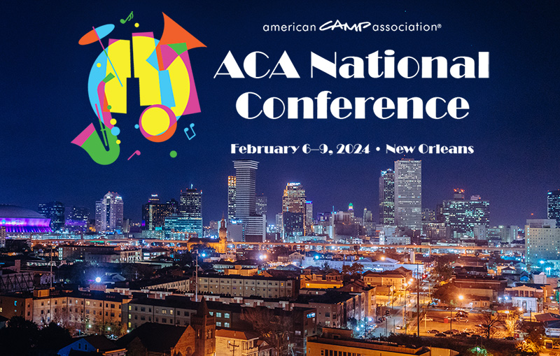 Conference logo with city skyline at night