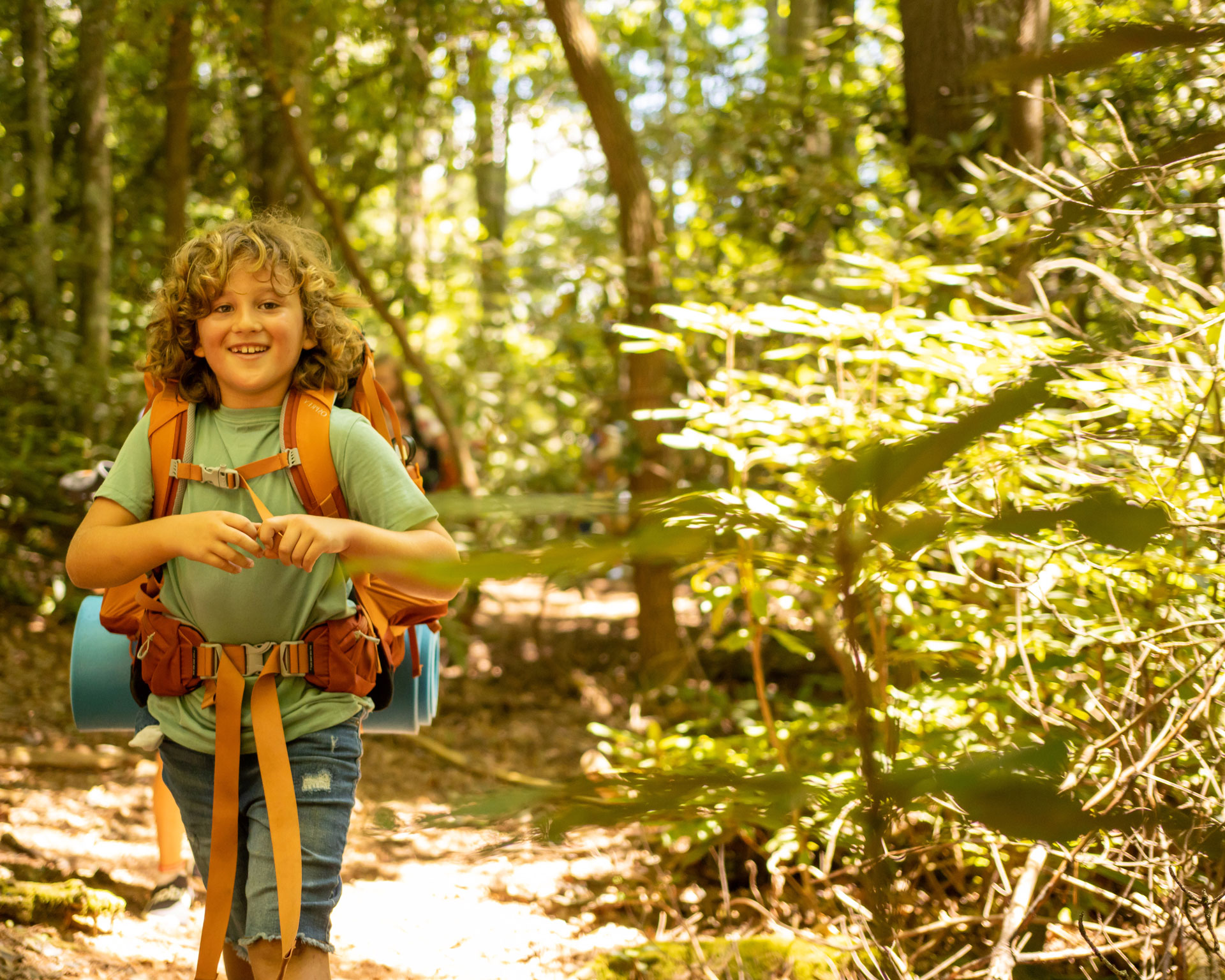 Camper with backpack in woods