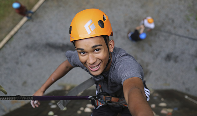 Camper climbing tower