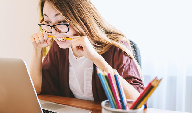 woman biting pencil