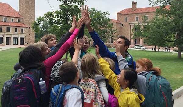 campers and staff high-fiving