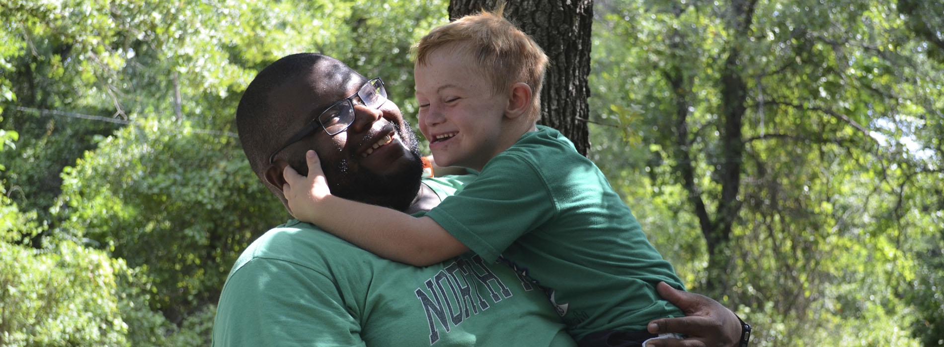 Camper and counselor hug