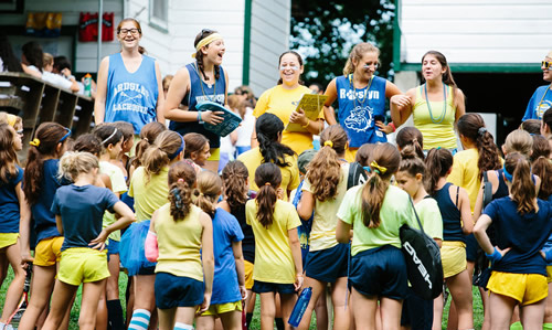Staff addressing campers with announcements