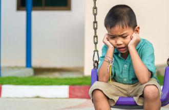 stock photo of child sitting on swing