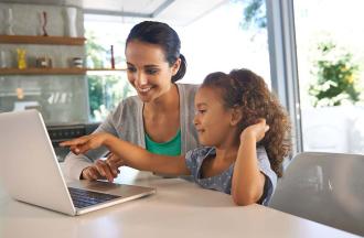 mom and daugher looking at laptop