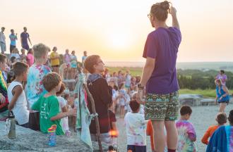 camp staff with campers at sunset