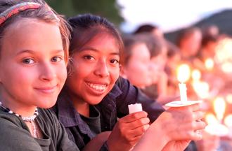 Two Campers with Candles Smiling