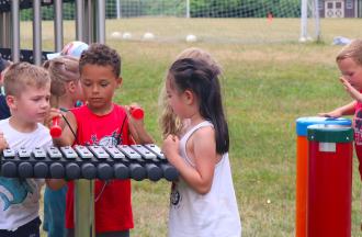 campers playing outdoor instruments