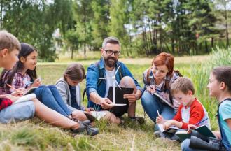 stock photo of aduts and campers outdoors