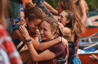 camper and staff hugging