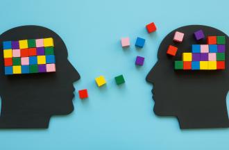 Two head silhouettes with colorful cubes