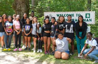 campers posing for photo outside