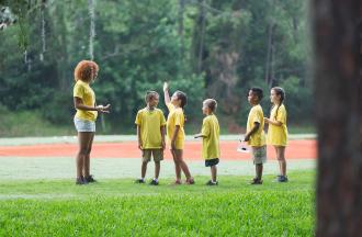 counselor with campers outdoors