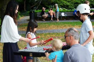 adults and kids playing Duo instrument