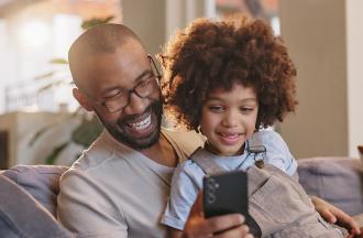 stock photo of parent and child looking at phone