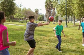 Kids playing with ball outdoors