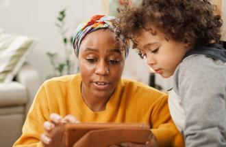 parent and child looking at tablet