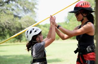 camper and staff high-five