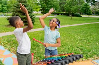 kids having fun with outdoor instrument
