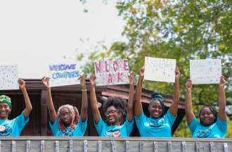 staff welcoming campers