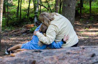 camper and staff hugging