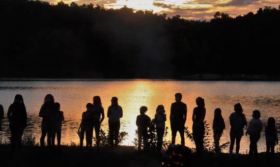 campers and staff silhouettes at sunset