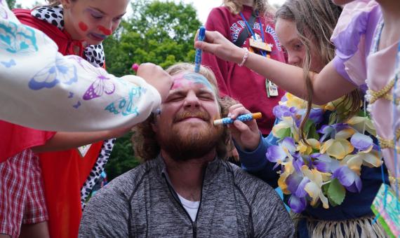 campers drawing on staff member's face