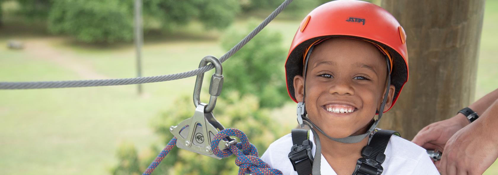 Smiling boy on ropes course