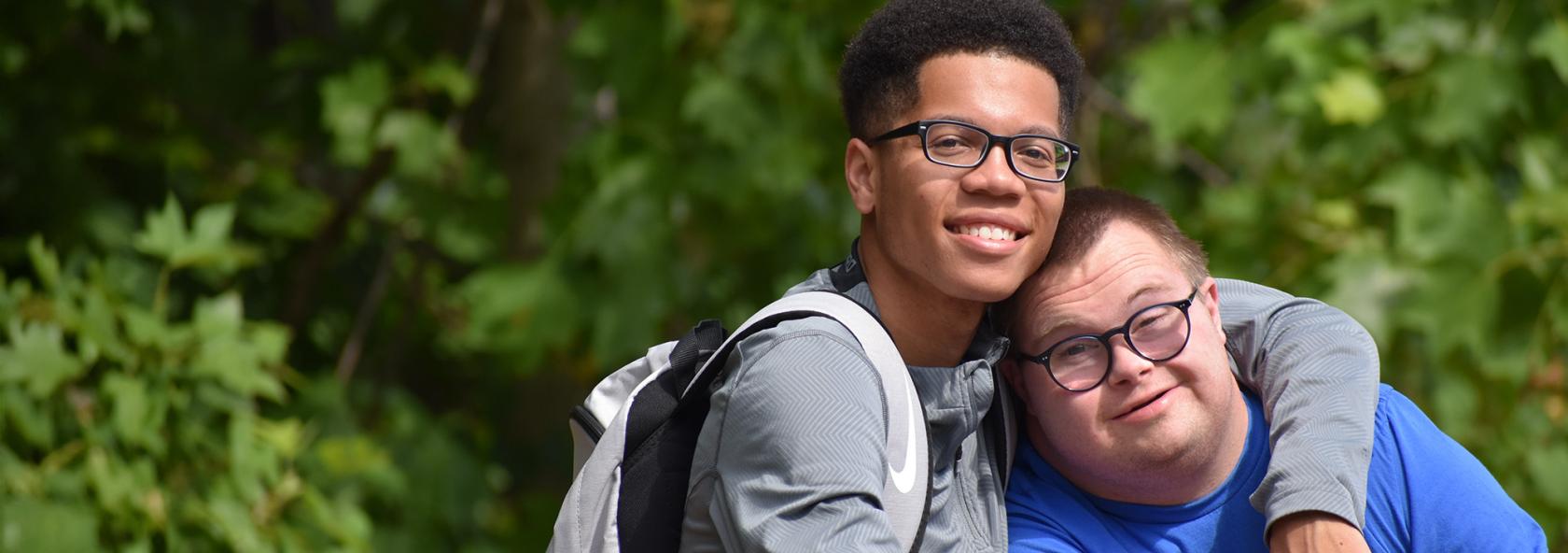 Camper and counselor posing for photo