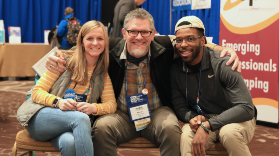 Three conference attendees smiling