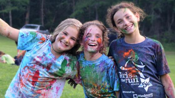Campers covered in paint smiling for camera