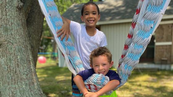 Campers next hammock smiling for camera