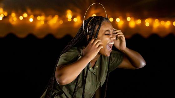 Camper singing passionately on stage