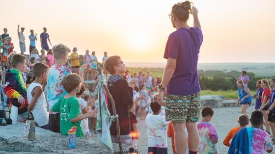 camp staff with campers at sunset