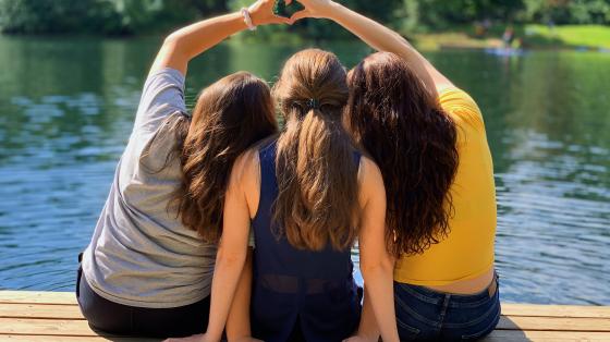 group of people making a heart with their hands