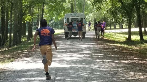 staff running to great camper bus