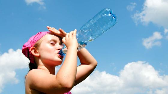 girl drinking from water bottle