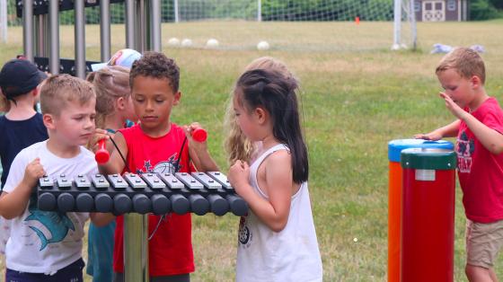 campers playing outdoor instruments