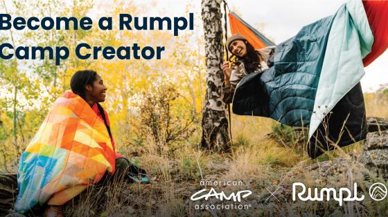Two people wearing rumpl blankets outdoors