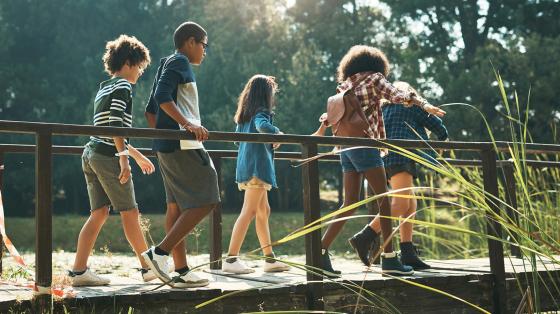 Kids walking over bridge